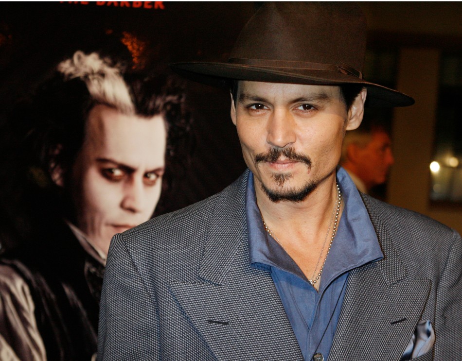 Johnny Depp poses next to a poster featuring him in character at a special screening of the DreamWorks Pictures film Sweeney Todd The Demon Barber of Fleet Street at Paramount Studios in Hollywood, California December 5, 2007.