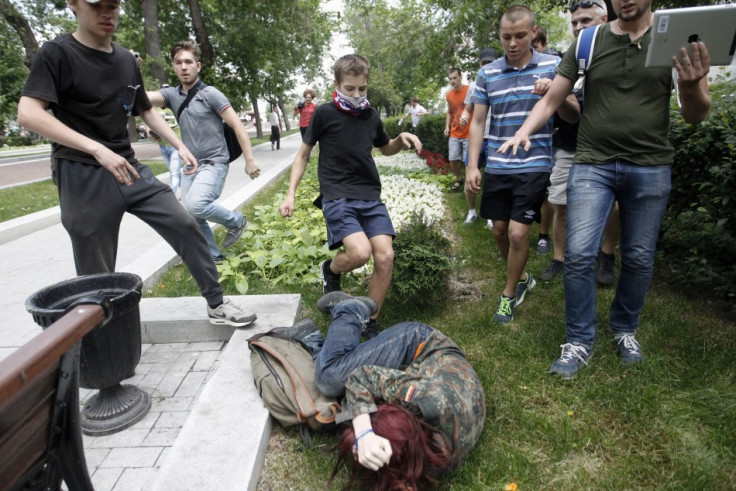 Youths kick a gay rights activist during a protest against a proposed new law termed by the State Duma (Reuters)