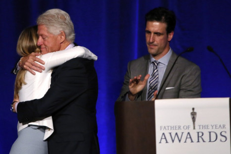 Former U.S. president Bill Clinton is congratulated by his daughter Chelsea Clinton for his nomination as 'Father of the Year' at a lunch in New York, June 11, 2013.