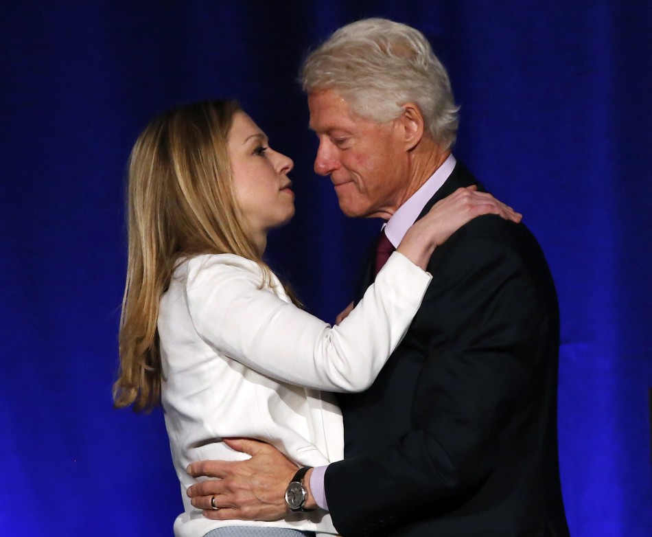 Former U.S. president Bill Clinton is congratulated by his daughter Chelsea Clinton for his nomination as Father of the Year at a lunch in New York, June 11, 2013.