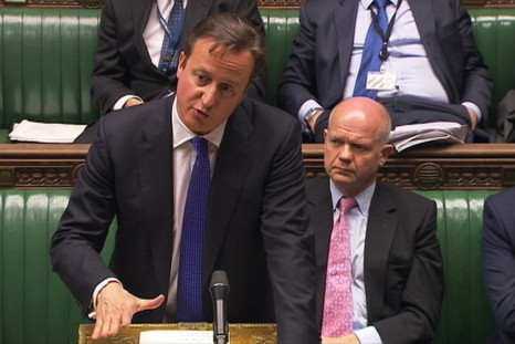 Britain's Prime Minister David Cameron, flanked by Foreign Secretary William Hague (R)