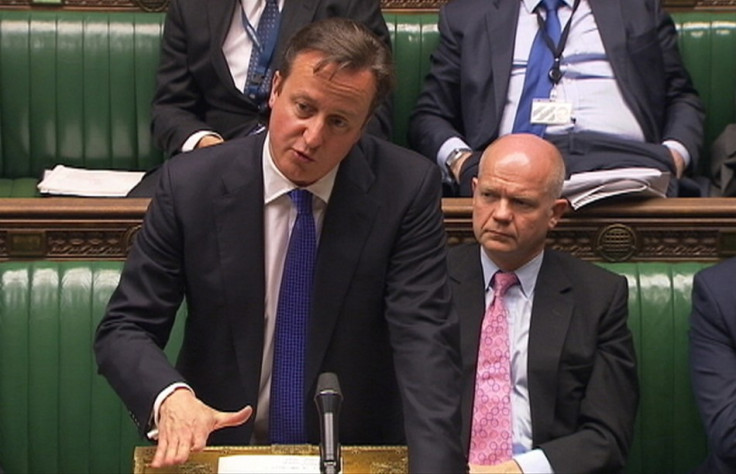 Britain's Prime Minister David Cameron, flanked by Foreign Secretary William Hague (R)