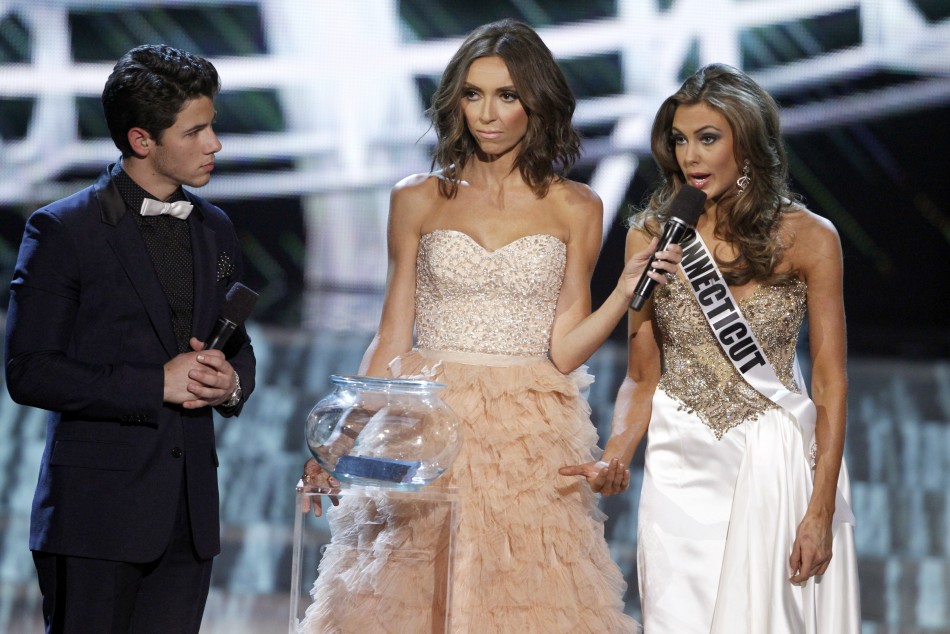 Miss Connecticut Erin Brady R responds to a question with show hosts Nick Jonas of the Jonas Brothers and Giuliana Rancic, co-anchor of E News, during the Miss USA pageant at the Planet Hollywood Resort and Casino in Las Vegas, Nevada June