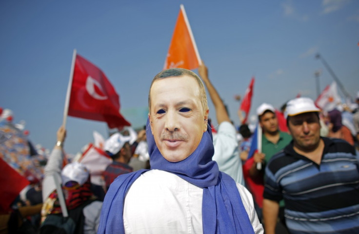 A supporter wears a mask showing Turkish Prime Minister Tayyip Erdogan during a rally of ruling AK party in Istanbul