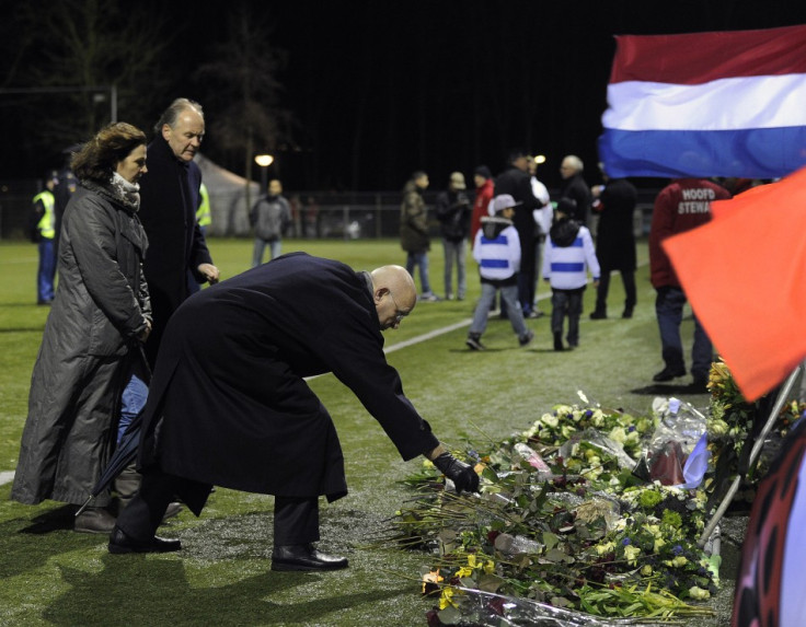 Michael van Praag, president of the Royal Dutch Football Association (KNVB), places flowers on the pitch of club Buitenboys to commemorate Richard Nieuwenhuizen (Reuters)