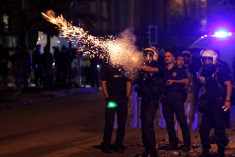 Riot police fire tear gas towards protesters during clashes in Kennedy Street in central Ankara