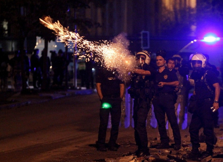 Riot police fire tear gas towards protesters during clashes in Kennedy Street in central Ankara
