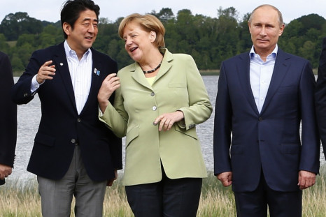 Japan's Prime Minister Shinzo Abe (L), German Chancellor Angela Merkel (C) and Russia's President Vladimir Putin take part in a group photo at the G8 Summit, at Lough Erne, near Enniskillen, in Northern Ireland June 18, 2013. (Photo: REUTERS)