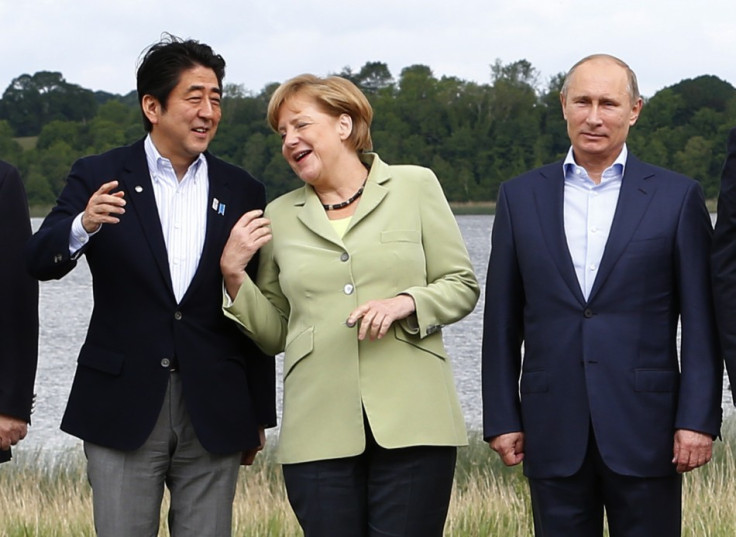 Japan's Prime Minister Shinzo Abe (L), German Chancellor Angela Merkel (C) and Russia's President Vladimir Putin take part in a group photo at the G8 Summit, at Lough Erne, near Enniskillen, in Northern Ireland June 18, 2013. (Photo: REUTERS)