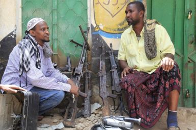 Suspected al-shabaab members and their weapons are paraded