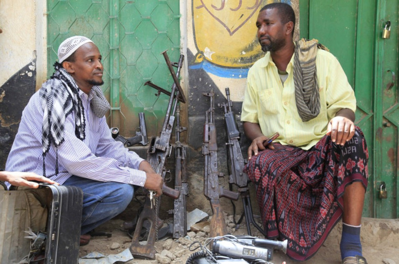 Suspected al-shabaab members and their weapons are paraded