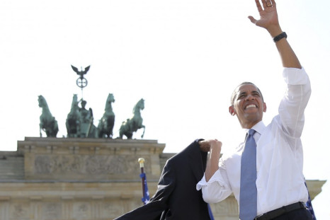US President Barack Obama waves after giving a speech in front of the Brandenburg Gate in Berlin
