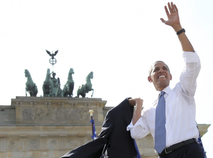 US President Barack Obama waves after giving a speech in front of the Brandenburg Gate in Berlin