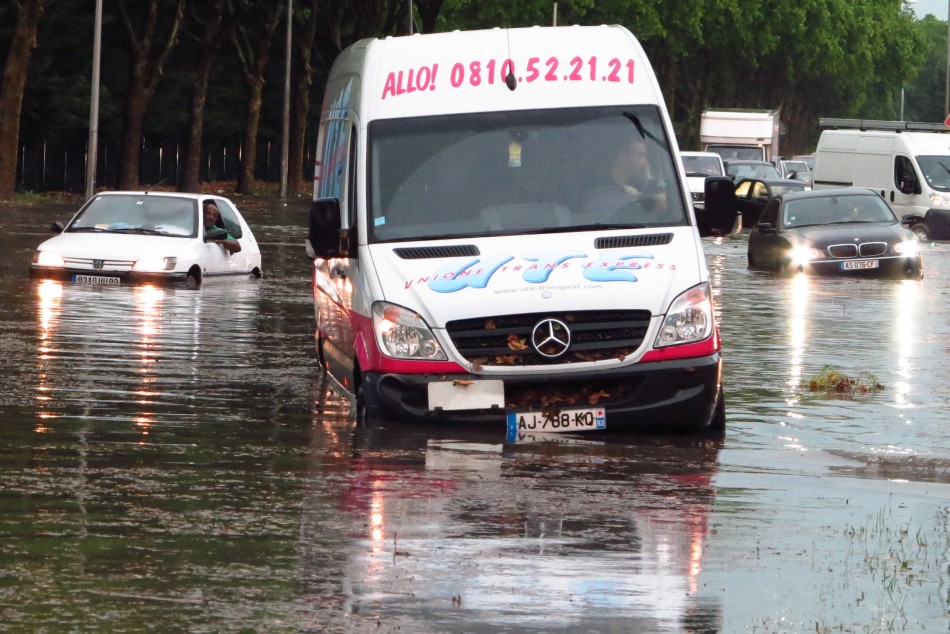 Cars and a delivery van are blocked on a street after a heavy thunderstorm with rain caused local flooding in Aulnay sous Bois near Paris, June 19, 2013.