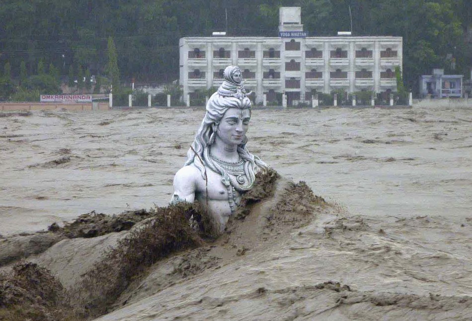 A submerged statue of the Hindu Lord Shiva stands amid the flooded waters of river Ganges at Rishikesh in the Himalayan state of Uttarakhand June 17, 2013.