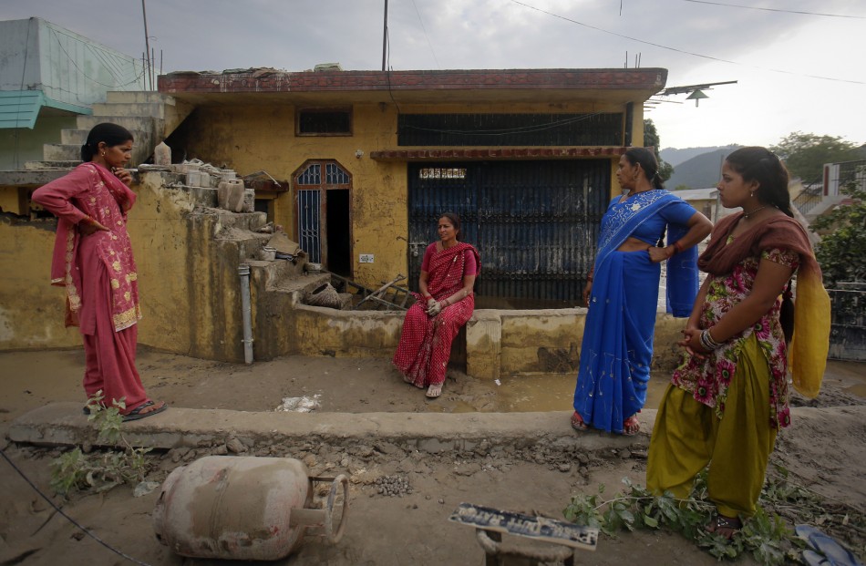 Residents stand outside their houses that were damaged due to floods in Srinagar, in the Himalayan state of Uttarakhand June 19, 2013.