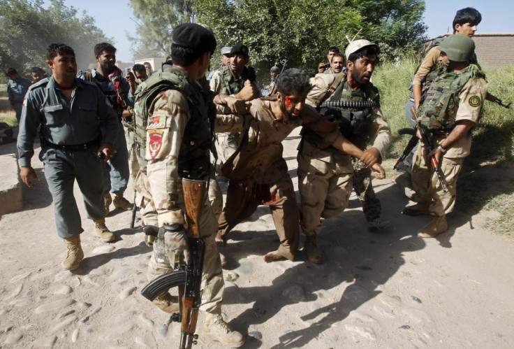 Afghan security forces with a captured suspected Taliban rebel