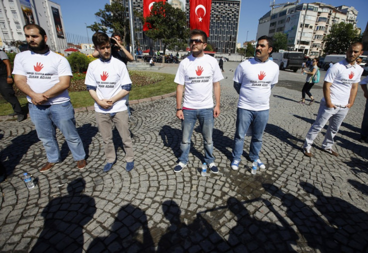 Counter-protesters against the "Standing Man" face people standing in a silent protest at Taksim Square in Istanbul