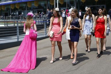 Women look at the dress of a race goer on the second day of the Royal Ascot