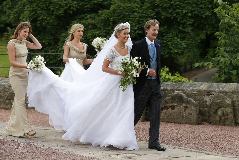 Melissa Percy is escorted by her father, Ralph Percy, the Duke of Northumberland, and bridesmaid Chelsey Davy 2nd L as she arrives for her wedding to Thomas van Straubenzee, at St Michaels Church in Alnwick, northern England June 22, 2013.
