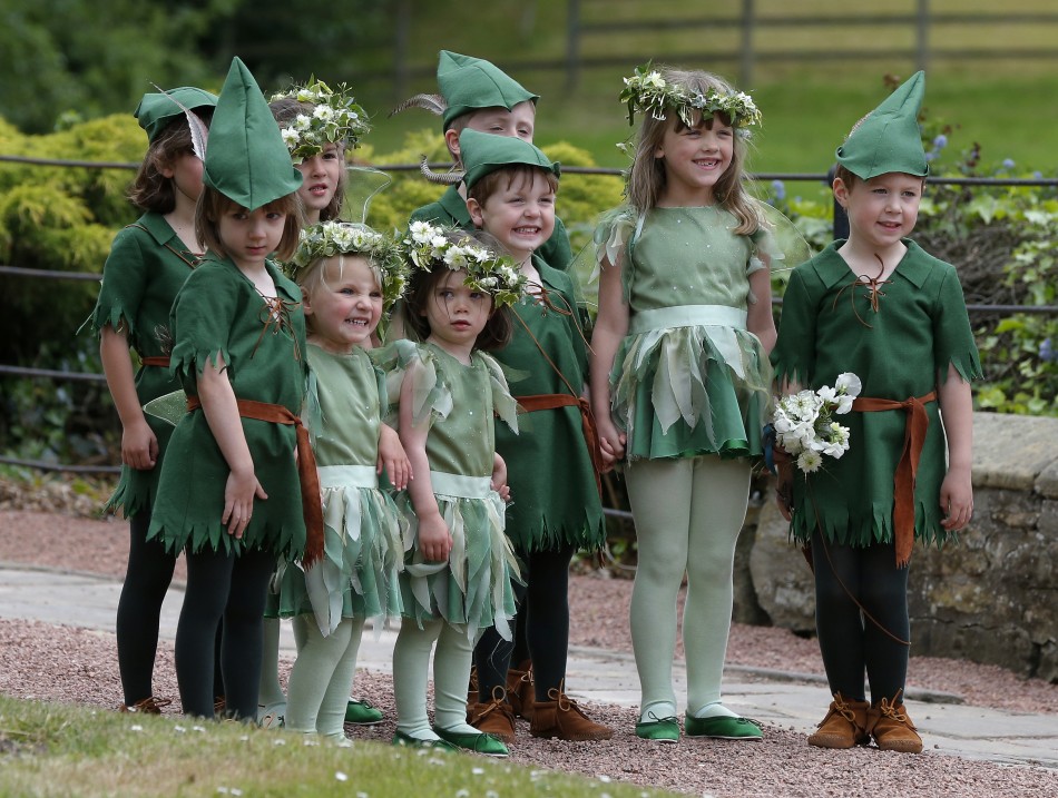 Flower girls and page boys pose for a photograph