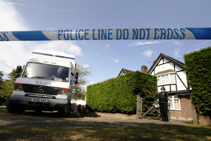 A police officer stands by a cordon close to the house of Saad al-Hilli and his family in Claygate