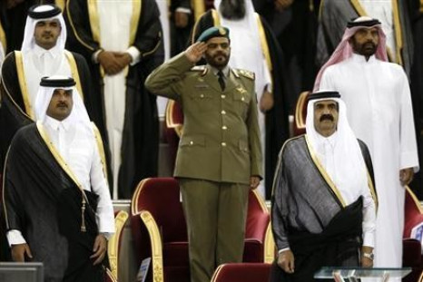 Qatar's Emir Sheikh Hamad bin Khalifa al-Thani (R) stands next to his son Crown Prince Sheikh Tamim bin Hamad al-Thani before the Emir Cup final match between Al-Sadd and Al-Rayyan at Khalifa stadium in Doha May 18, 2013.