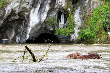 Top of Grotto and Statue of Mary peek abover flood waters