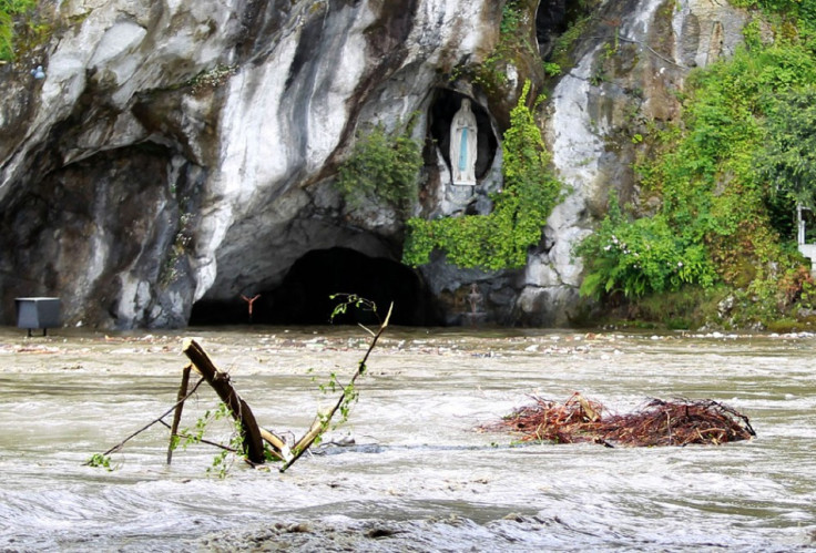 Top of Grotto and Statue of Mary peek abover flood waters