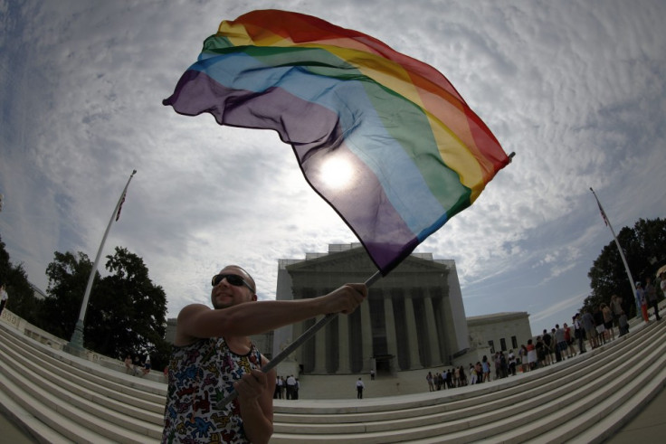 Gay marriage supporter Vin Testa waves a rainbow flag in anticipation of U.S. Supreme Court rulings