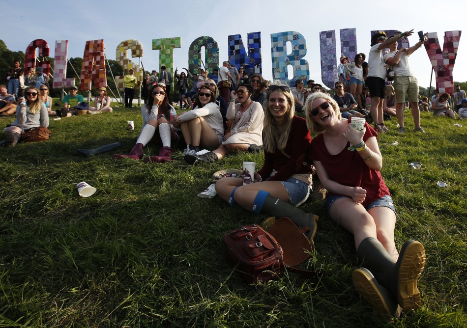 Festival goers watch their friends play rounders