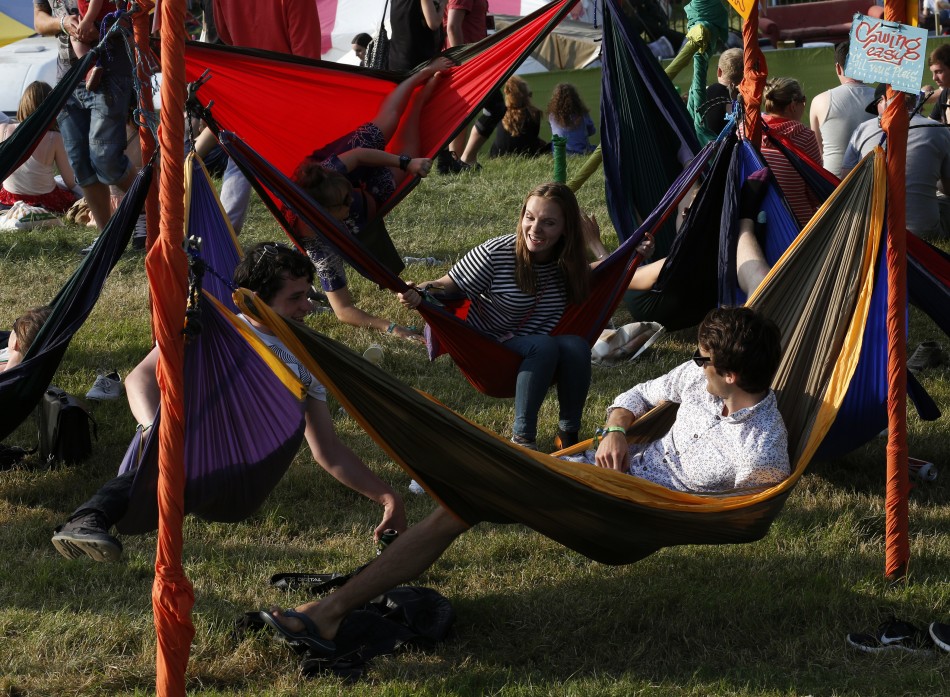 Festival goers relax in hammocks