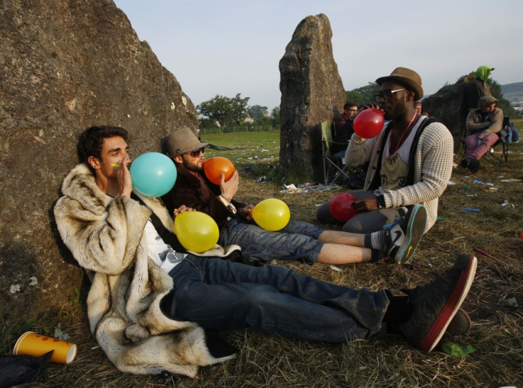 Festival goers inhale laughing gas at sunrise at the stone circle