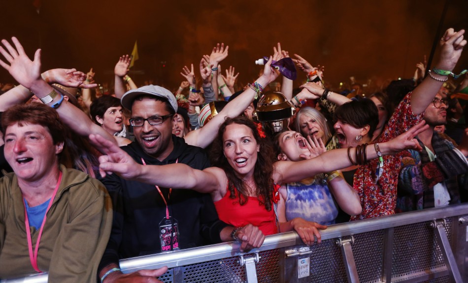 Festival goers cheer as Nile Rodgers and his band Chic perform on the third day of the Glastonbury music festival at Worthy Farm in Somerset June 28, 2013.