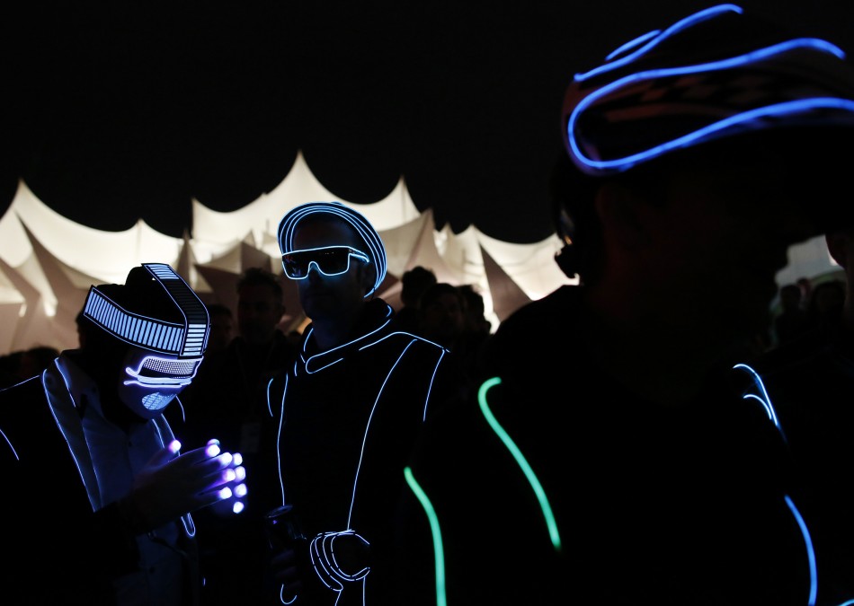Gary Wright and Jon Williams wear light costumes in Shangri La field at Glastonbury music festival at Worthy Farm in Somerset, June 29, 2013.