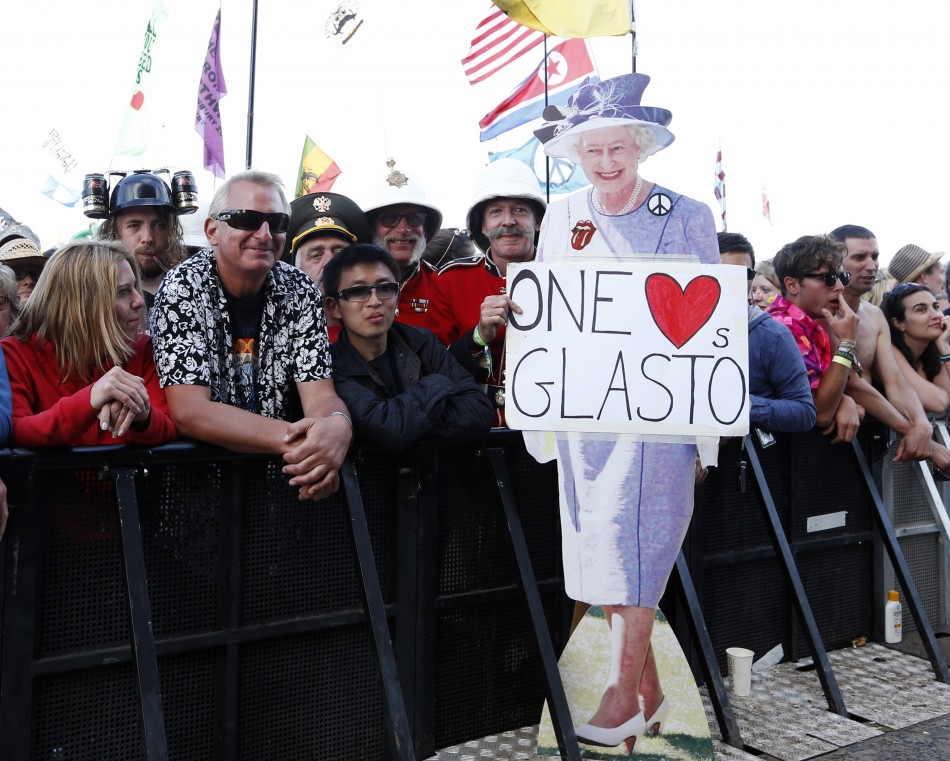A member of the crowd holds a lifesize cutout of Queen Elizabeth at the Pyramid Stage at Glastonbury music festival at Worthy Farm in Somerset, June 29, 2013.