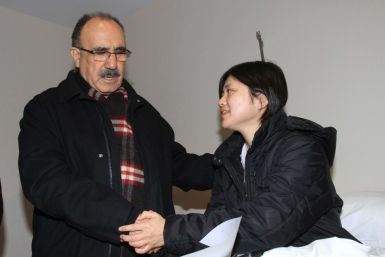Turkey's Deputy Prime Minister Besir Atalay (L) visits Japanese earthquake survivor Miyuki Konna