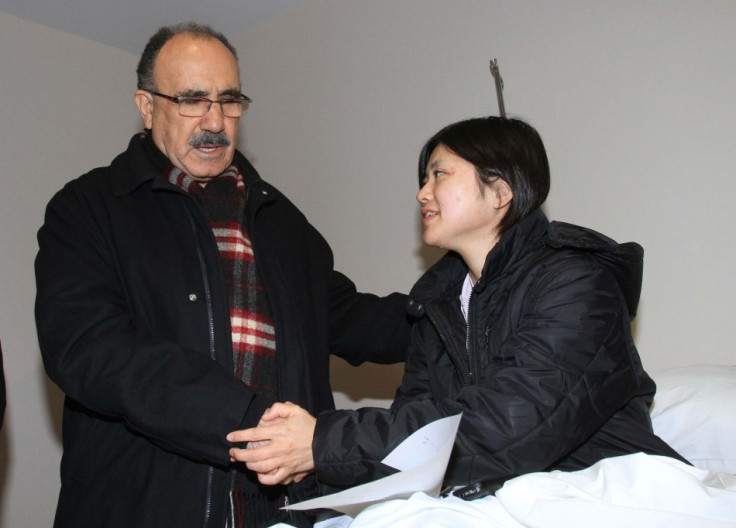 Turkey's Deputy Prime Minister Besir Atalay (L) visits Japanese earthquake survivor Miyuki Konna