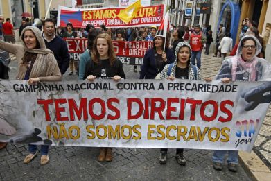 Youth march with a banner saying "We have rights, we are not slaves" during a protest against unemployment in Lisbon  (Photo: REUTERS)