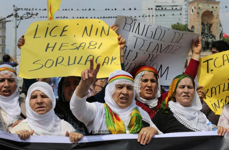 Kurdish protesters shout slogans during a demonstration against Turkish security forces