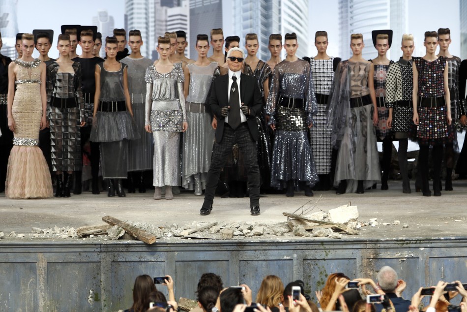 German designer Karl Lagerfeld front C appears with models at the end of his Haute Couture Fall Winter 20132014 fashion show for French fashion house Chanel in Paris July 2, 2013.