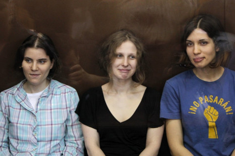 Pussy Riot members in glass-walled cage during a court hearing in Moscow (Reuters)