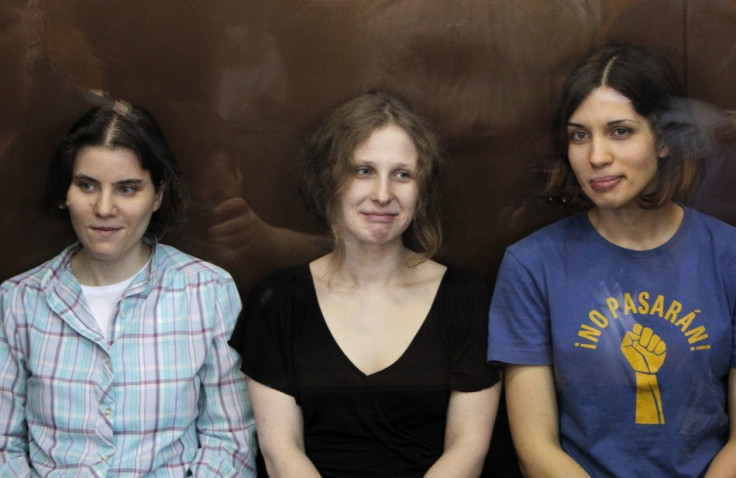 Pussy Riot members in glass-walled cage during a court hearing in Moscow (Reuters)