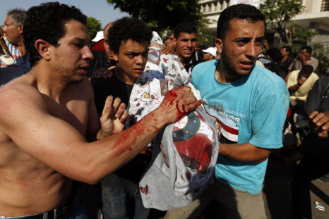 Protesters, who support former Egyptian President Mohamed Mursi, carry the covered body of a victim