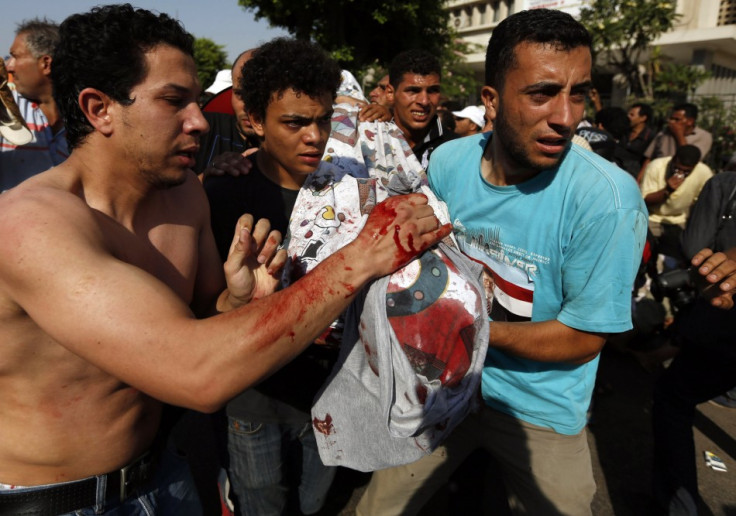 Protesters, who support former Egyptian President Mohamed Mursi, carry the covered body of a victim