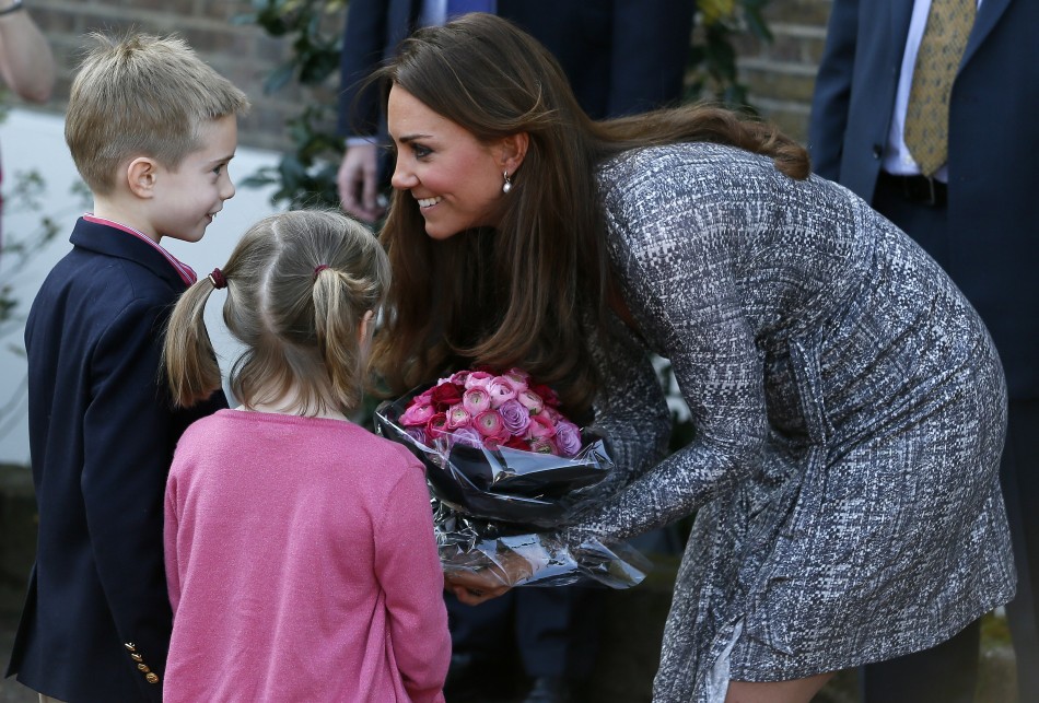 Catherine, Duchess of Cambridge receives flowers from children as she leaves Hope House addiction treatment centre after an official visit in London February 19, 2013.