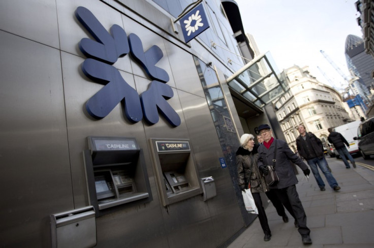 Pedestrians walk past a Royal Bank of Scotland building in central London