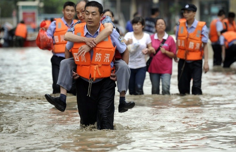 Chengdu policeman carries a flood victim to safety