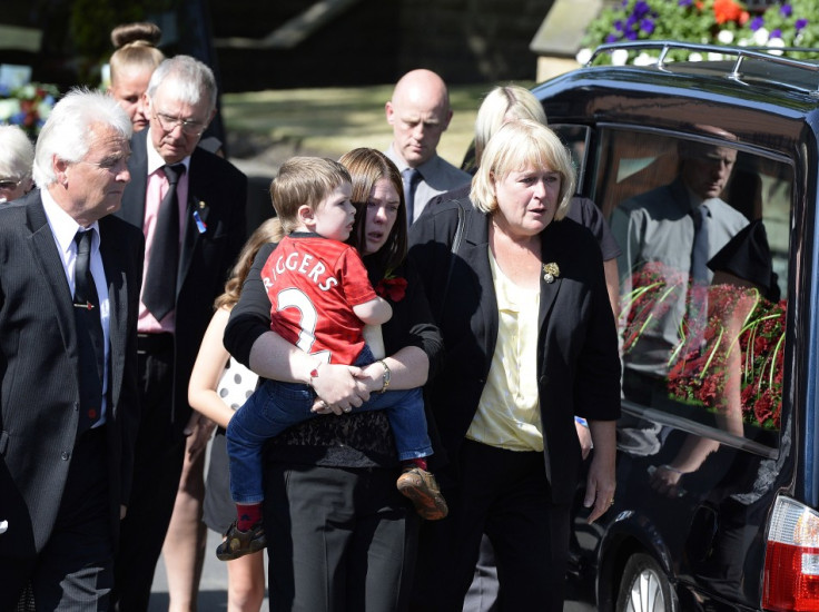 Rebecca Rigby (C), the wife of Fusilier Lee Rigby, and son Jack, arrive for a vigil at the Parish Church in Bury (Reuters)