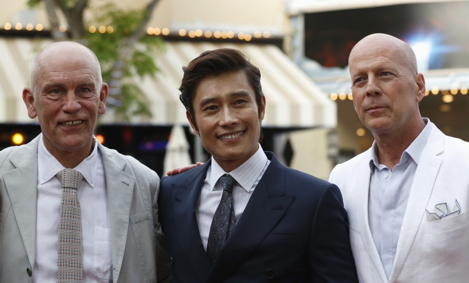 Cast members John Malkovich L, Lee Byung-hun of South Korea C and Bruce Willis pose at the premiere of the film Red 2 in Los Angeles, California July 11, 2013.